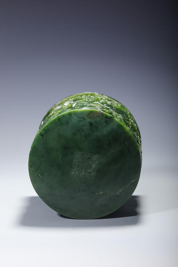 SEAVIEW AUCTIONS PTY LTDA Spinach Green Jade Cylindrical Brush Pot Carved with Mountain and Scholar Landscape, Wood Stand, China, 18th century