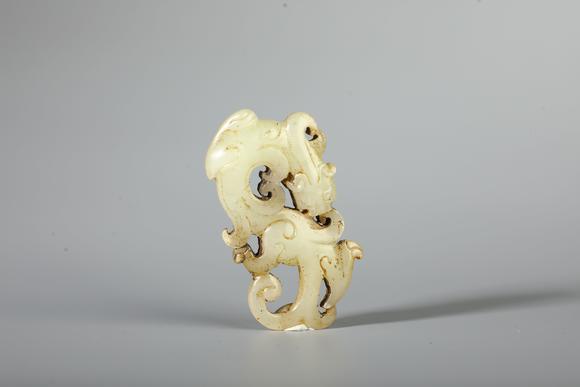 SEAVIEW AUCTIONS PTY LTDA Pale White Jade Openwork Coiled Dragon Pendant, China, 2nd BCE–2nd CE