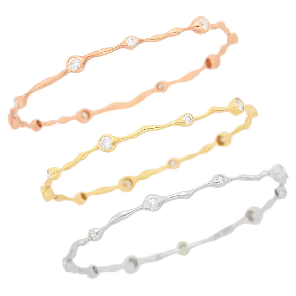 DOYLE Auctioneers & AppraisersThree Yellow, White and Rose Gold and Diamond Bangle Bracelets