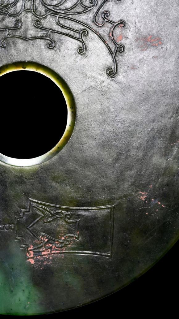 Castle AuctionA Dark Green Jade Bi Disc with Incised Decoration, Neolithic, Circa 3300–2300 C BC Pr.