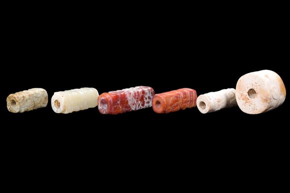 Castle AuctionA Group of Six Calcified & Reddish Jade Cong-Style Beads, Liangzhu, Circa 3300–2300 C BC Pr.