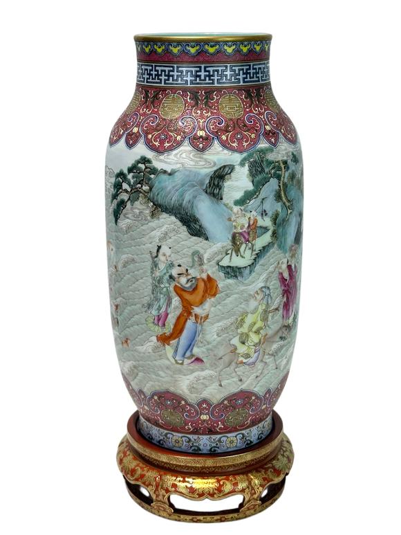Castle AuctionA Chinese Rouge Famille Rose vase adorned with the Eight Immortals' figures pattern, together with A Chinese porcelain stand, Qian Long Pr. 