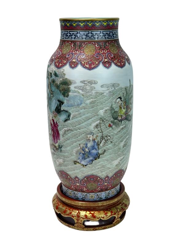 Castle AuctionA Chinese Rouge Famille Rose vase adorned with the Eight Immortals' figures pattern, together with A Chinese porcelain stand, Qian Long Pr. 