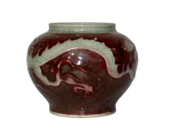 Castle AuctionThe underglaze red jar with hidden dragon pattern carvings, Ming Dynasty Pr. or earlier.