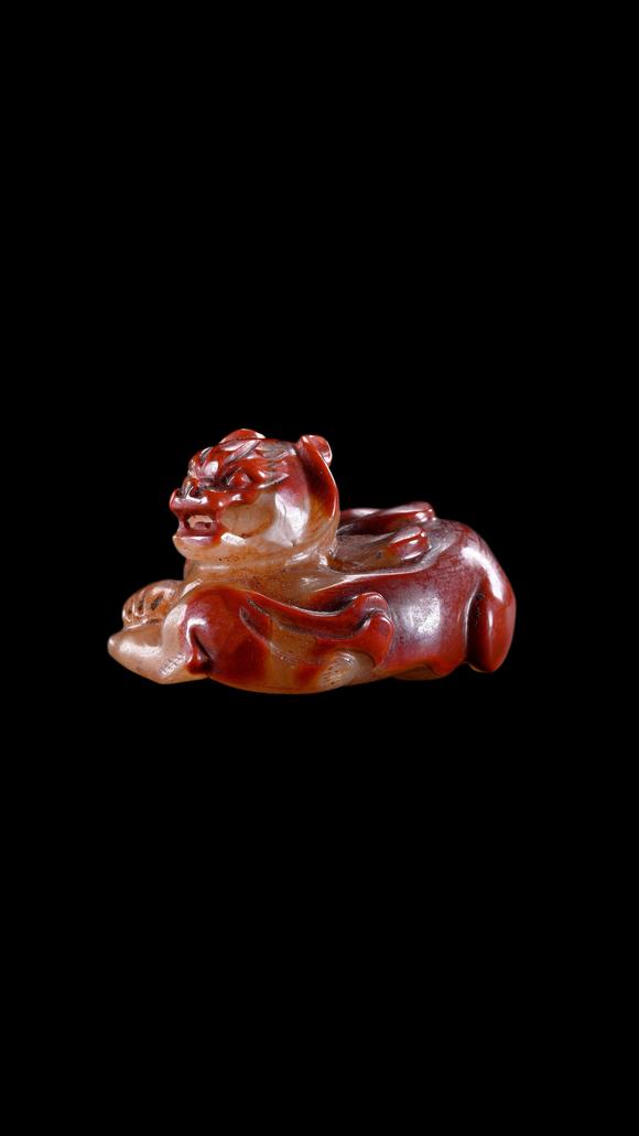 Castle AuctionA Reddish Jade Mythical Beast Carving, Han, Circa 2nd C BC–2nd C AD Pr.