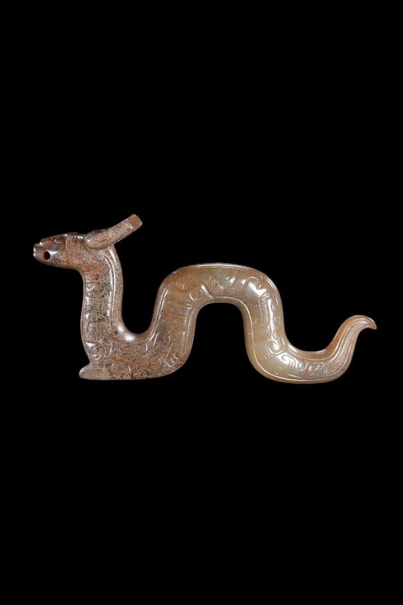 Castle AuctionA Calcified Brown Jade Dragon Pendant, Han, Circa 2nd C BC–2nd C AD Pr.