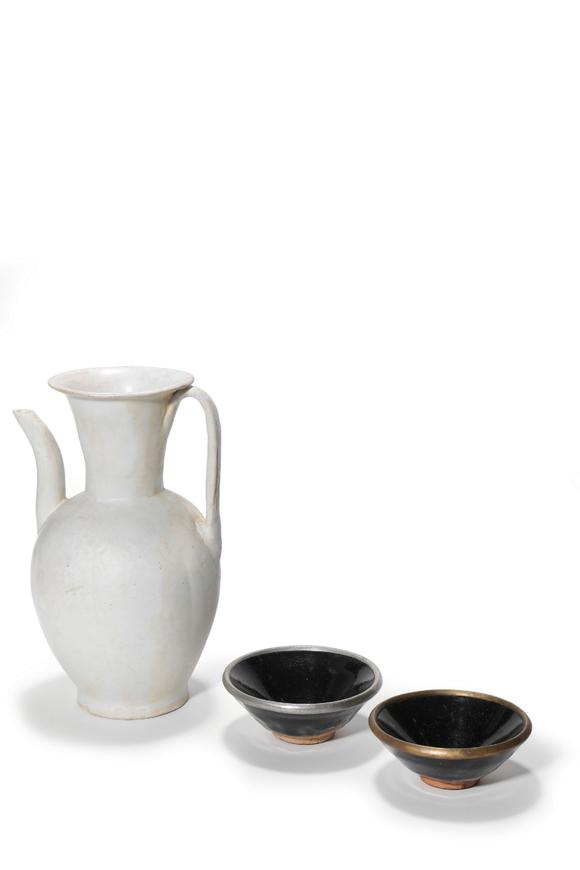 Castle AuctionA White Glaze Ewer and Two Black Glaze Tea Bowls with Metal Rims, 10th–13th C Pr.