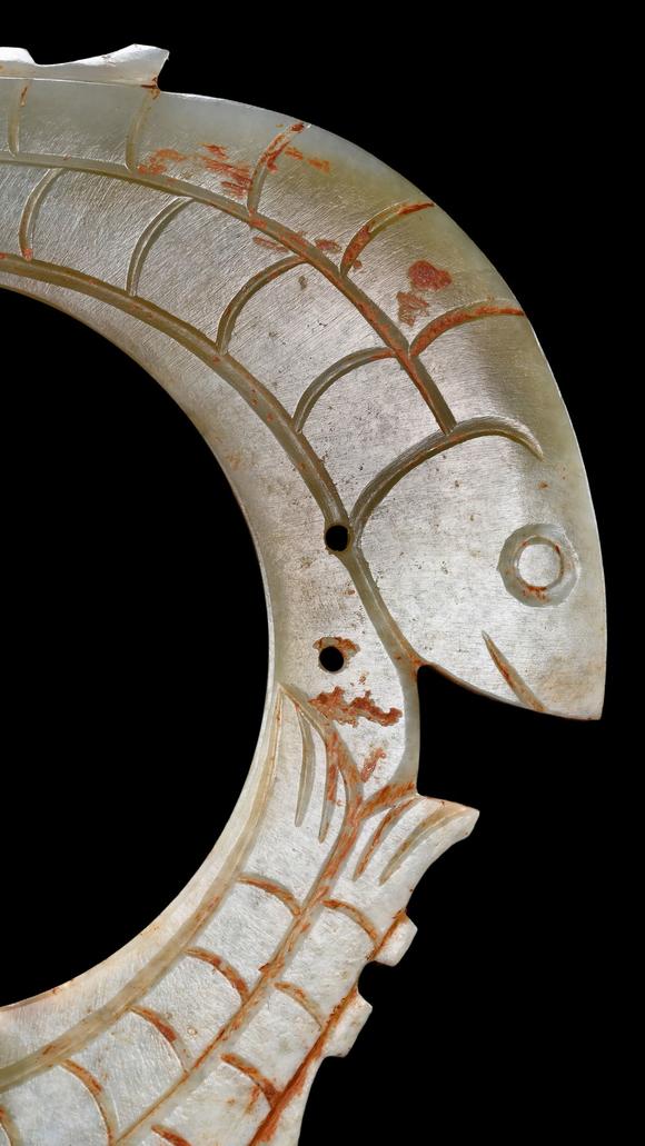 Castle AuctionA Pale Jade Dragon-Ring Pendant with Red Pigment Traces, Han, Circa 2nd C BC–2nd C AD Pr.