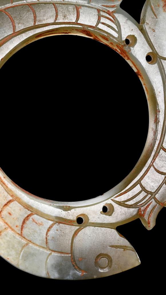 Castle AuctionA Pale Jade Dragon-Ring Pendant with Red Pigment Traces, Han, Circa 2nd C BC–2nd C AD Pr.