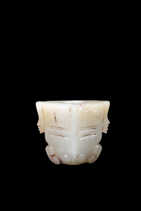 Castle AuctionA Pale Celadon Jade Taotie Mask Bead, Shang, Circa 13th–11th C BC Pr.