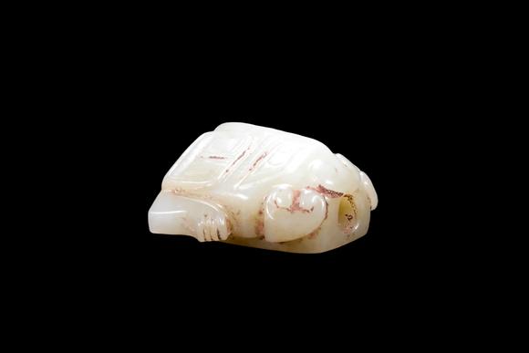 Castle AuctionA Pale Celadon Jade Taotie Mask Bead, Shang, Circa 13th–11th C BC Pr.