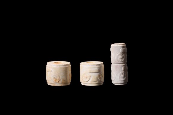Castle AuctionA Three Calcified White Jade Human-Face Beads, Liangzhu, Circa 3300–2300 C BC Pr.