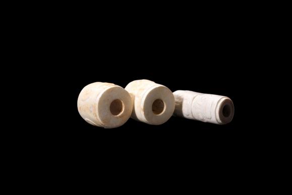 Castle AuctionA Three Calcified White Jade Human-Face Beads, Liangzhu, Circa 3300–2300 C BC Pr.