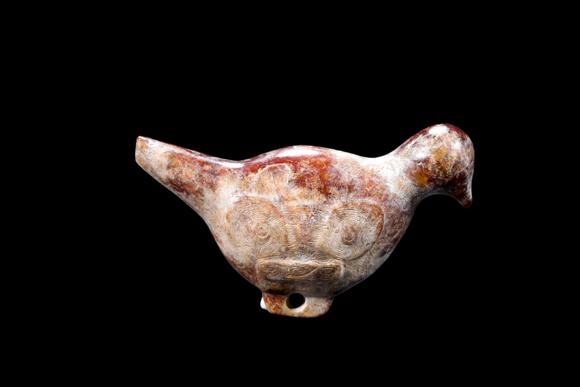 Castle AuctionA Mottled Reddish Brown Jade Bird Carving, Liangzhu, Circa 3300–2300 C BC Pr.