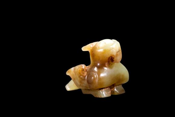 Castle AuctionA Pale Yellow Jade Recumbent Bird Carving, Late Shang, Circa 12th–11th C BC Pr.