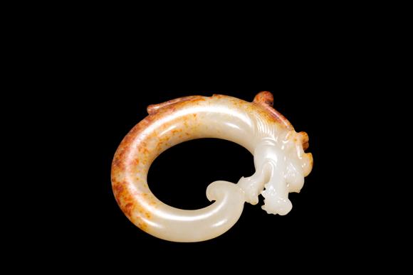 Castle AuctionA White Jade C-Shaped Dragon Pendant with Russet Veins, Han, Circa 2nd C BC–2nd C AD Pr.