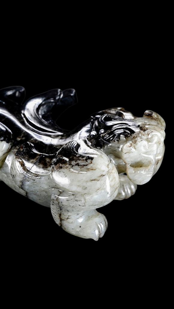 Castle AuctionA Mottled Black & White Jade Crouching Tiger Carving, Han, Circa 2nd C BC–2nd C AD Pr.
