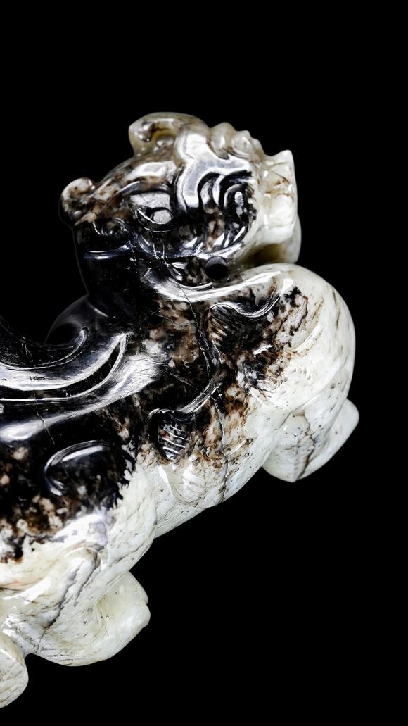 Castle AuctionA Mottled Black & White Jade Crouching Tiger Carving, Han, Circa 2nd C BC–2nd C AD Pr.