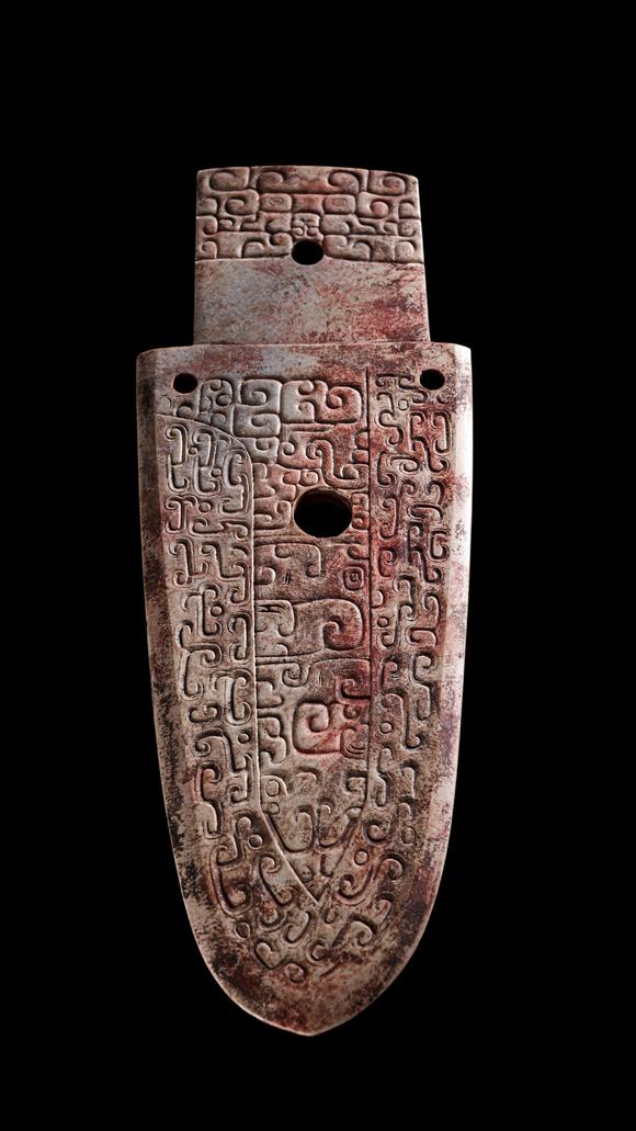 Castle AuctionA Calcified Brown Jade Carved Gui Pendant, Shang, Circa 13th–11th C BC Pr.