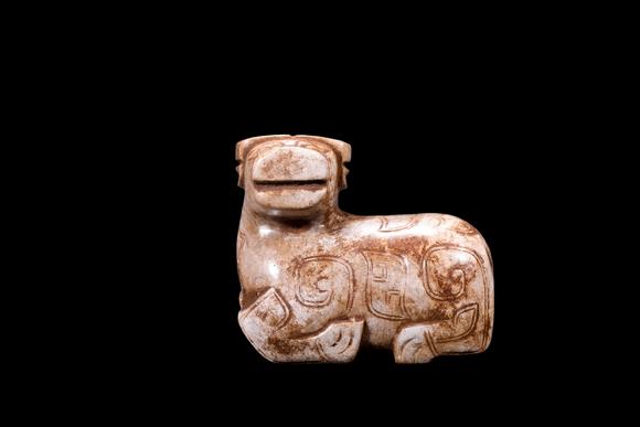 Castle AuctionA Calcified Pale Jade Recumbent Ox Carving, Shang, Circa 13th–11th C BC Pr.