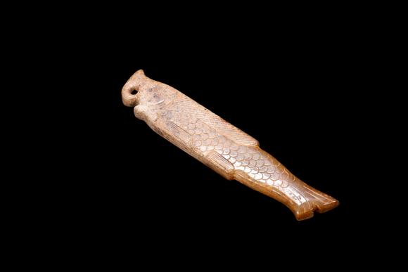 Castle AuctionA Calcified Yellow Jade Fish Pendant, Shang, Circa 13th–11th C BC Pr.