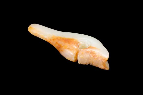 Castle AuctionA Pale Jade Dragon Tooth Pendant with Russet Inclusions, Shang, Circa 13th–11th C BC Pr.
