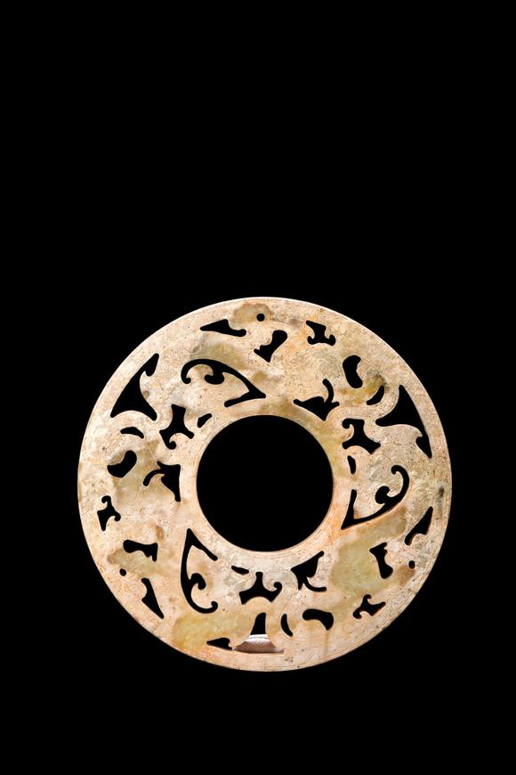 Castle AuctionA Calcified Yellow Jade Openwork Dragon Bi Disc, Han, Circa 2nd C BC–2nd C AD Pr.