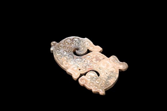 Castle AuctionA Mottled Calcified Jade S-Shaped Dragon Plaque, Spring & Autumn, Circa 8th–5th C BC Pr.