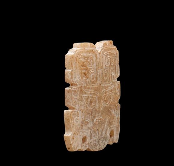 Castle AuctionA Calcified Brown Jade Taotie Mask Pendant, Western Zhou, Circa 10th–9th C BC Pr.