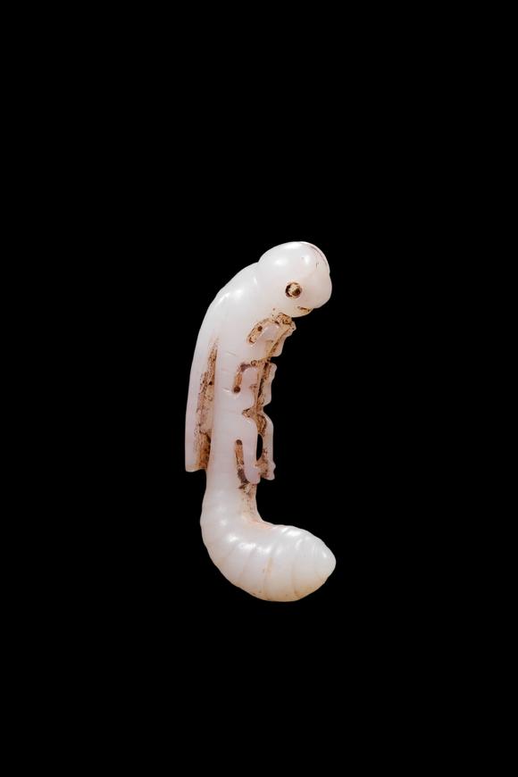 Castle AuctionA White Jade Silkworm Pendant with Russet Veins, Western Zhou, Circa 10th–8th C BC Pr.