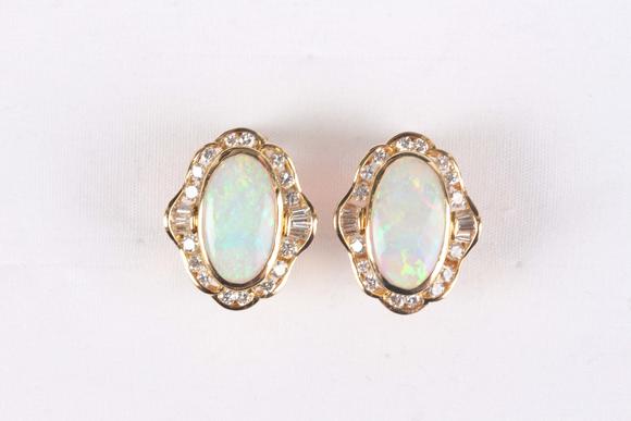 TooveysA pair of gold, opal and diamond shaped oval earrings, each collet set with the oval opal within a surround of tapered baguette and circular cut diamo