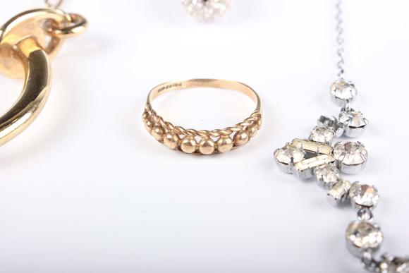 TooveysA small group of jewellery, comprising a 9ct gold ring in a bead and ropetwist design, weight 1.6g, ring size approx M1/2, a Swarovski gilt metal and