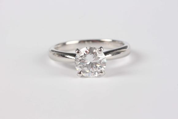 TooveysA platinum and diamond single stone ring, claw set with a circular cut diamond, weight 5.1g, diamond weight approx 1.43ct, ring size approx M, with a