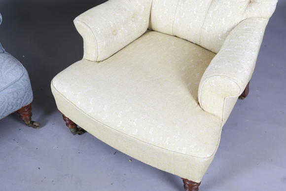 TooveysA near pair of late Victorian Howard & Sons armchairs, each buttoned back above scroll arms, on turned walnut legs with gilt brass caps and castors, e