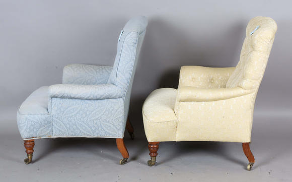 TooveysA near pair of late Victorian Howard & Sons armchairs, each buttoned back above scroll arms, on turned walnut legs with gilt brass caps and castors, e