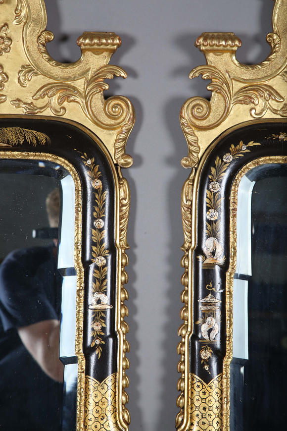 TooveysAn impressive pair of early 20th century Queen Anne style gilt and black japanned pier mirrors, each shaped crest with central shell and griffon heads