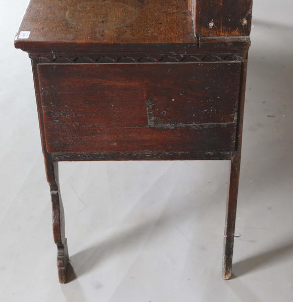 TooveysA good George III North Country oak dresser, the plate rack with pierced side panels above a lappet carved frieze and an arrangement of nine drawers,