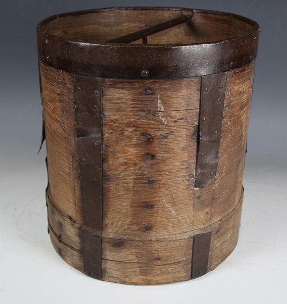 TooveysA 19th century French bentwood and metal bound grain measure, the underside stamped 'CORDIER', height 33cm, diameter 30cm.