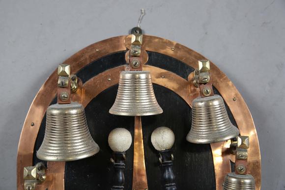 TooveysAn early 20th century copper mounted bell rack, hung with eight musical bells and two hammers, height 50cm.?Provenance: from the estate of a Sussex g
