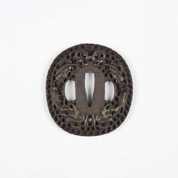 TooveysA fine Japanese oval iron tsuba, Edo period, with intricate