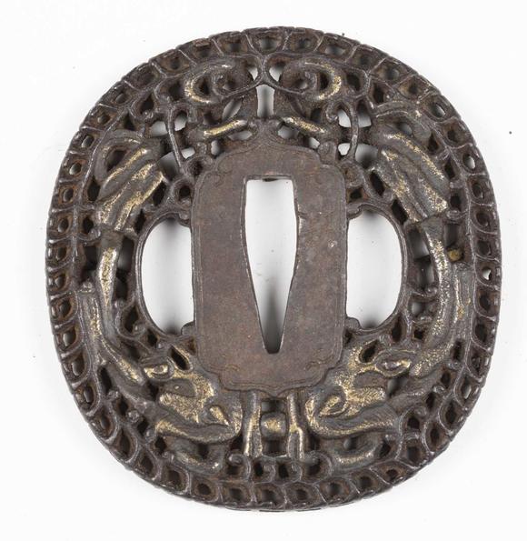 TooveysA fine Japanese oval iron tsuba, Edo period, with intricate