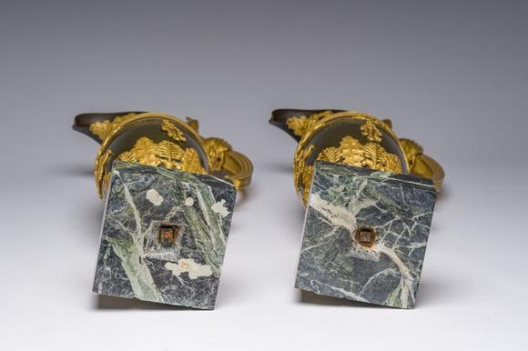 Coronari Auctions BVAn impressive pair of French Empire gilt and patinated bronze ewers on marble bases, attributed to Claude Galle, ca. 1800-1810
