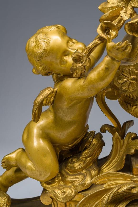 Coronari Auctions BVA fine and exceptional French Napoleon III gilt bronze three-piece clock garniture with putti and floral design, 19th C.