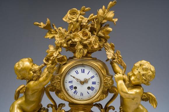 Coronari Auctions BVA fine and exceptional French Napoleon III gilt bronze three-piece clock garniture with putti and floral design, 19th C.