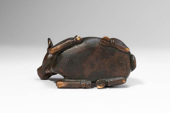 Apollo Art AuctionsMing Dynasty, Ca. AD 1368 - 1644, or earlier. >
A cast bronze figure of a recumbent bull, depicte
