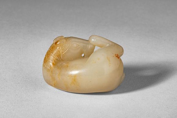 Apollo Art AuctionsMid Qing Dynasty, Ca. 18th century AD. >
A carved jade figure of a recumbent horse, depicted in a