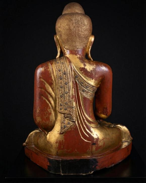 Bertolami Fine ArtBuddha figure in the lotus position. Lacquered and gilded wood with stucco and glass paste applications, set on a wooden and black lacquer base. Burma, Mandalay, 19th century.