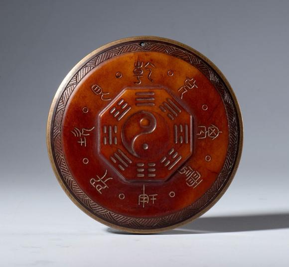 Bertolami Fine ArtA Hotan red jade plaque with protective Taoist inscriptions. At the center is the symbol of the Tao surrounded by the eight trigrams of the I Ching. China, 19th century