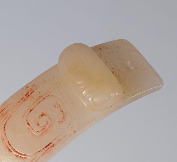 Bertolami Fine ArtSemicircular ornament in archaic style in engraved jade. Two cicada-shaped elements at the ends. Traces of red pigment in the engravings. China, Qing dynasty (1644–1912), late 19th century
