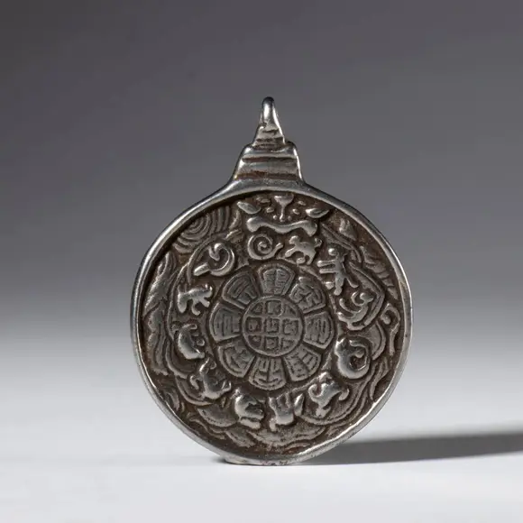 Bertolami Fine ArtJiu Gong Ba Gua amulet, made of silver alloy with a depiction of Mahakala. Tibet, 20th century